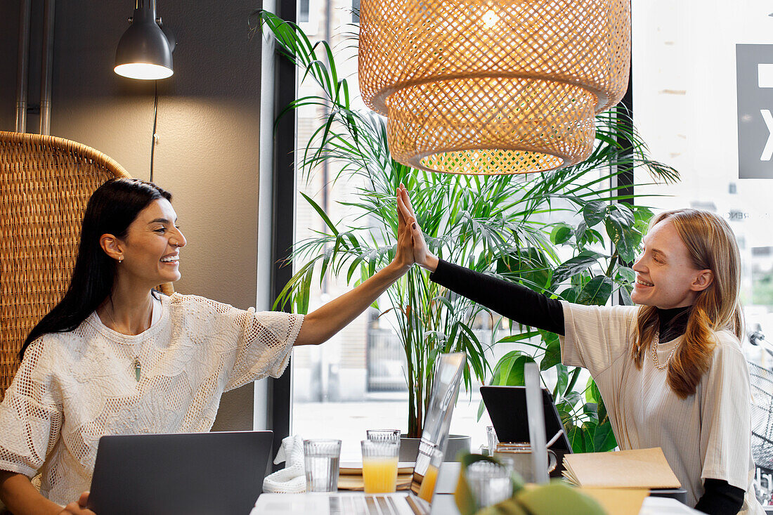 Female coworkers in cafe