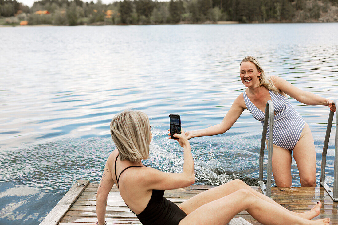 Happy female friends at lake