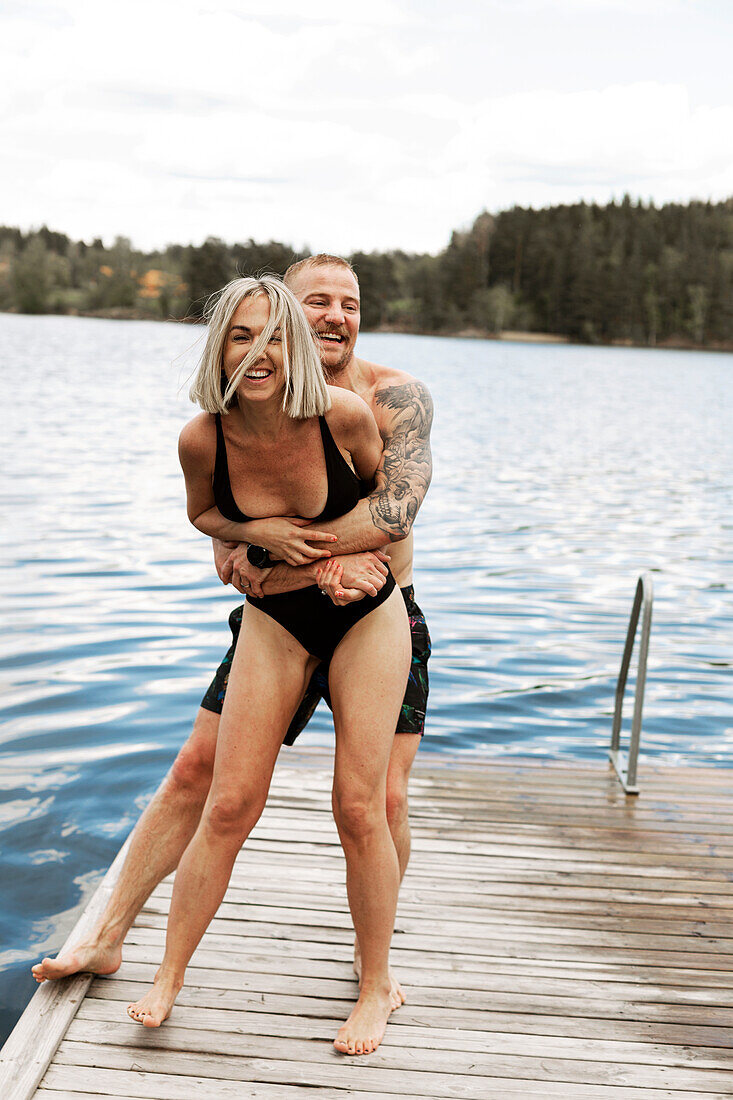 Happy couple standing on jetty