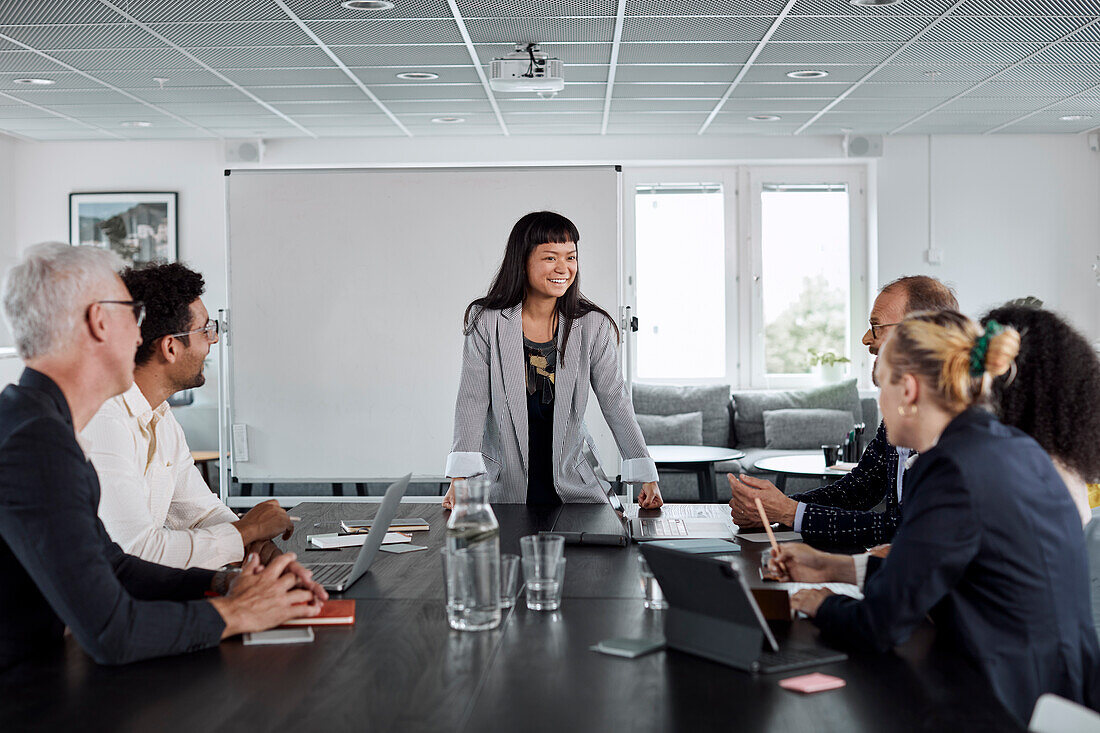 Smiling woman talking during business meeting