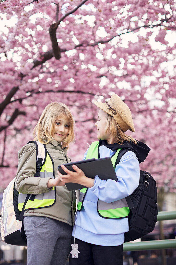 Smiling girls looking at digital tablet