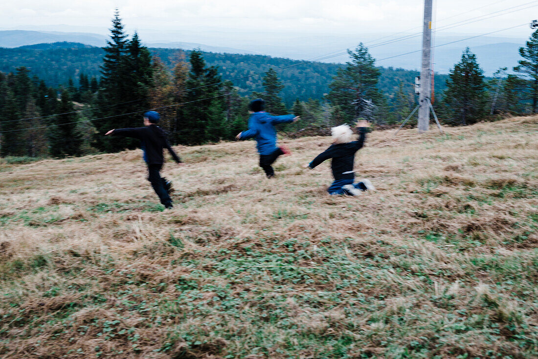 Kids running through meadow