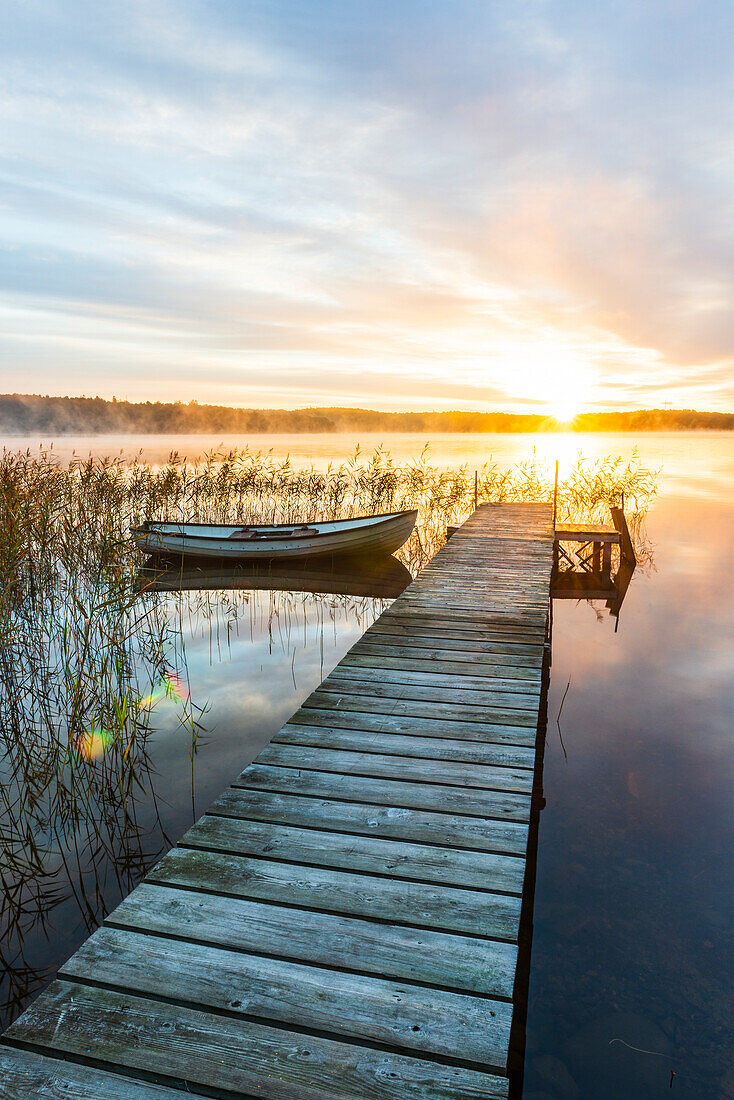 Boat in lake at sunrise