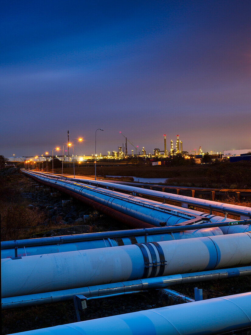 Pipeline outside city at dusk