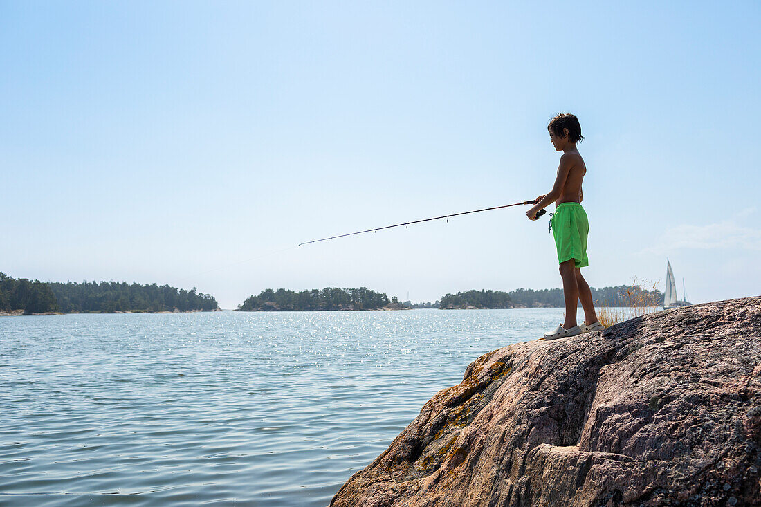 Boy fishing at lake