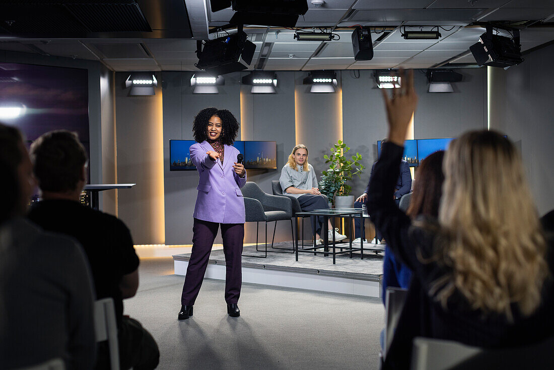 TV show audience member raising hand