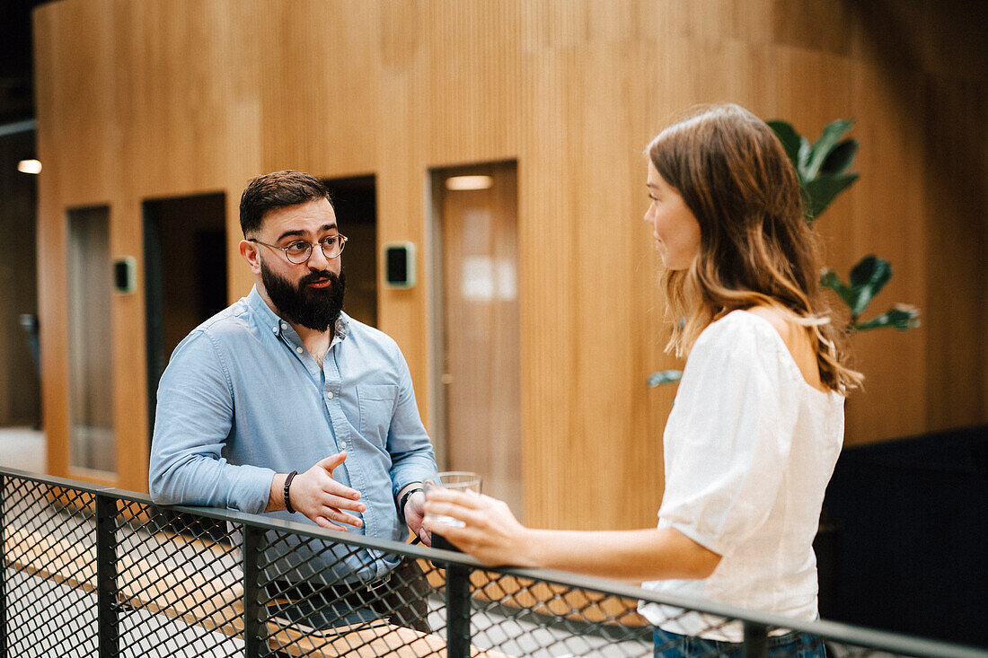 Coworkers talking at corridor