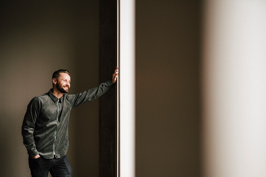 Man looking through window