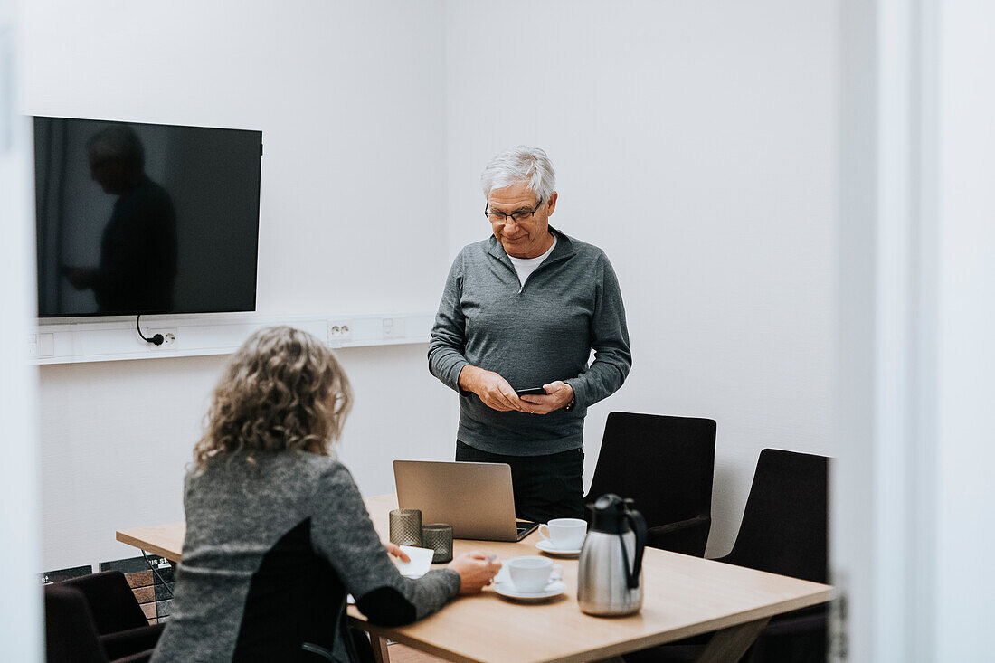 Coworkers talking in office