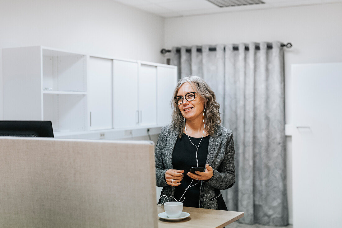 Smiling woman holding cell phone