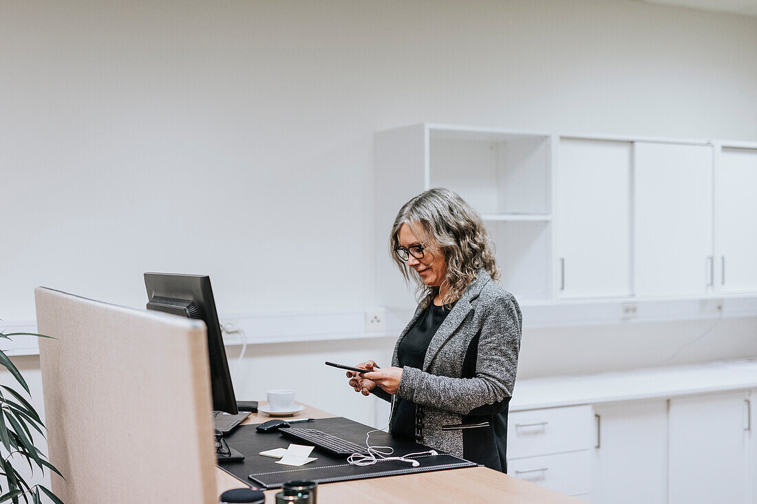 Smiling woman holding cell phone