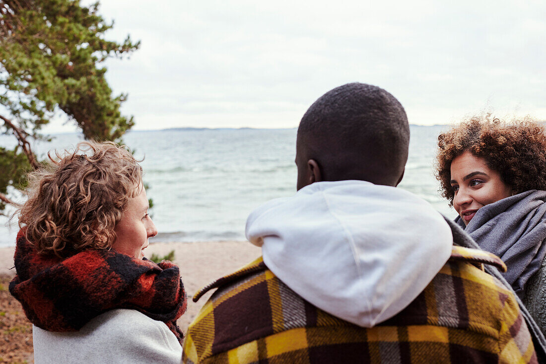 Group of friends standing on beach