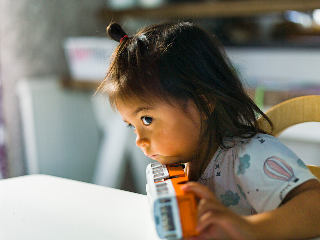 Girl playing with bus toy