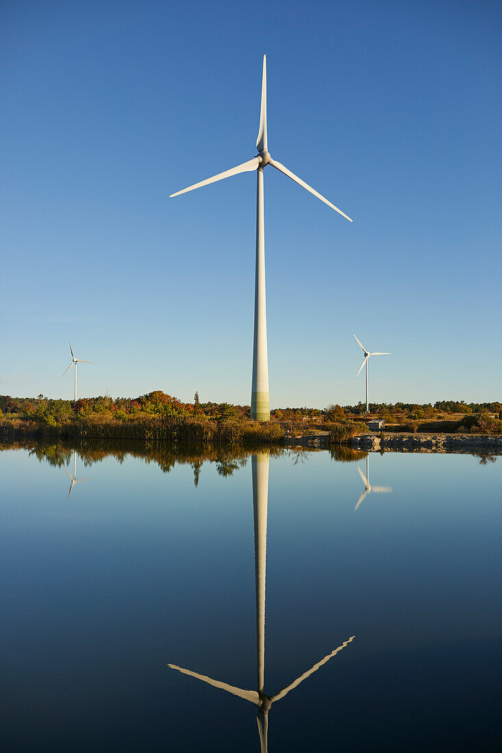 View of wind turbine reflecting in water