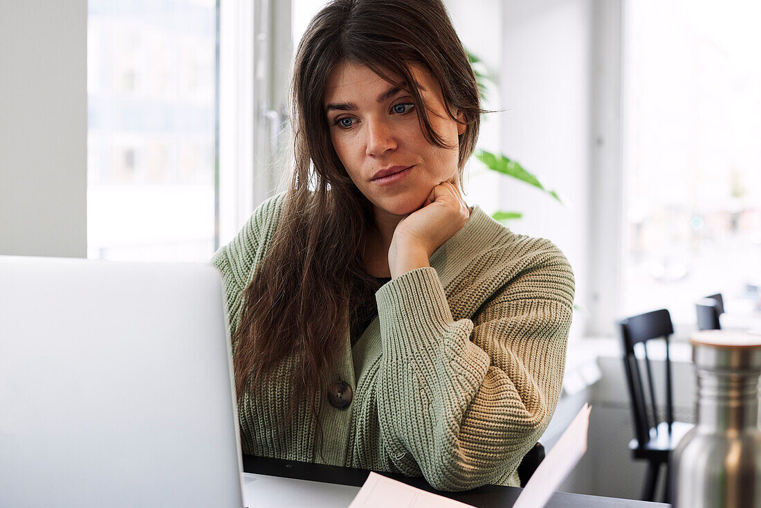 Smiling woman using laptop