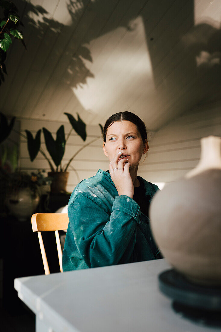 Woman sitting at table at home