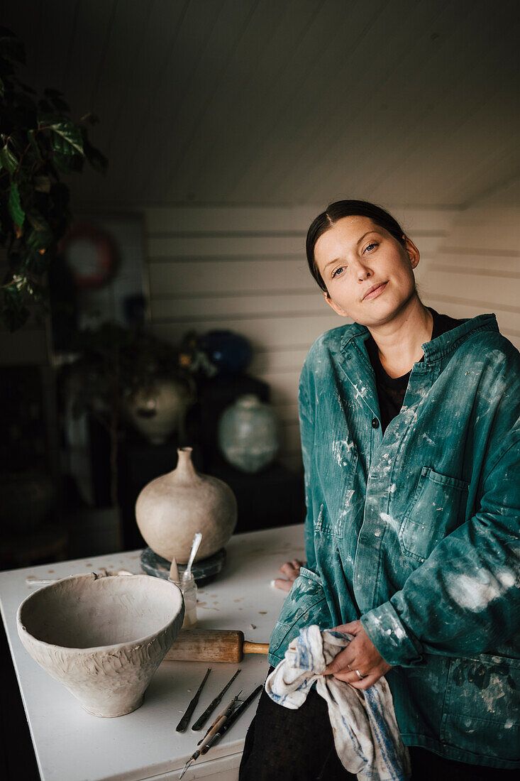 Portrait of female potter in workshop