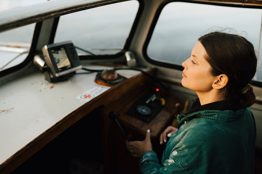 Junge Frau fährt Motorboot