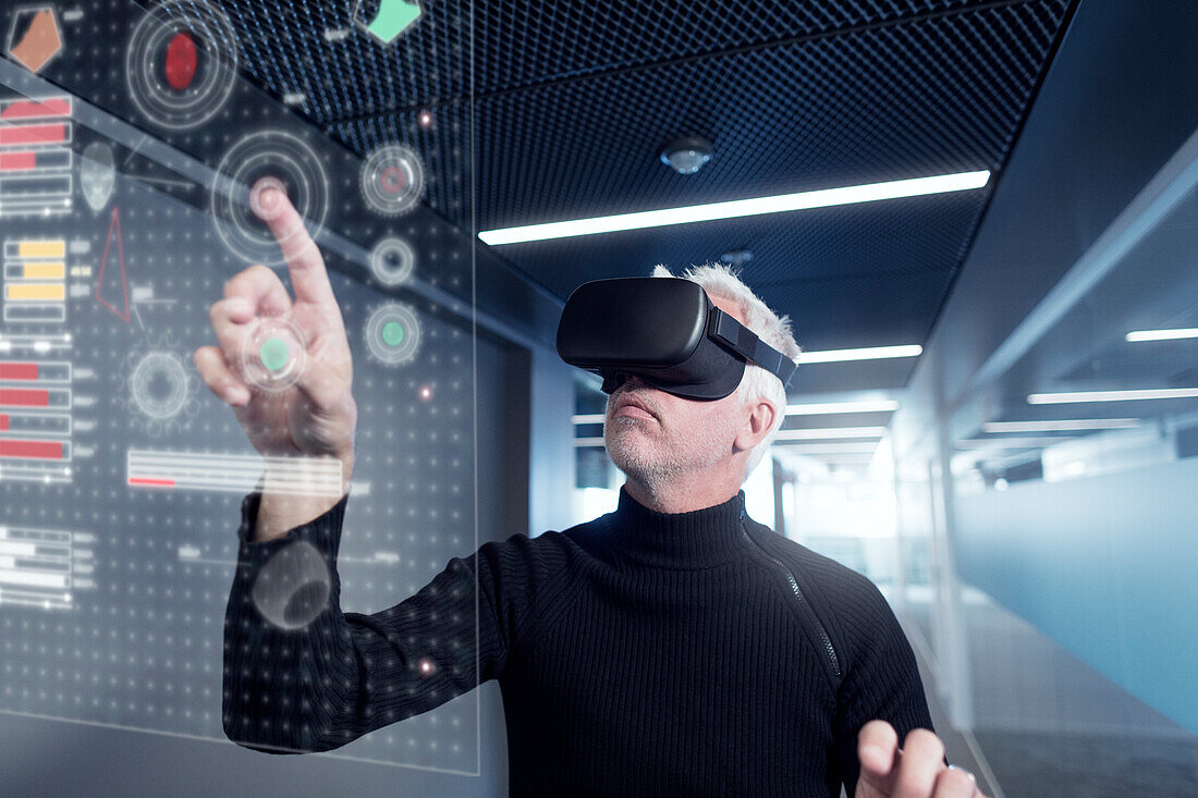 Senior man in virtual reality headset using advanced technology