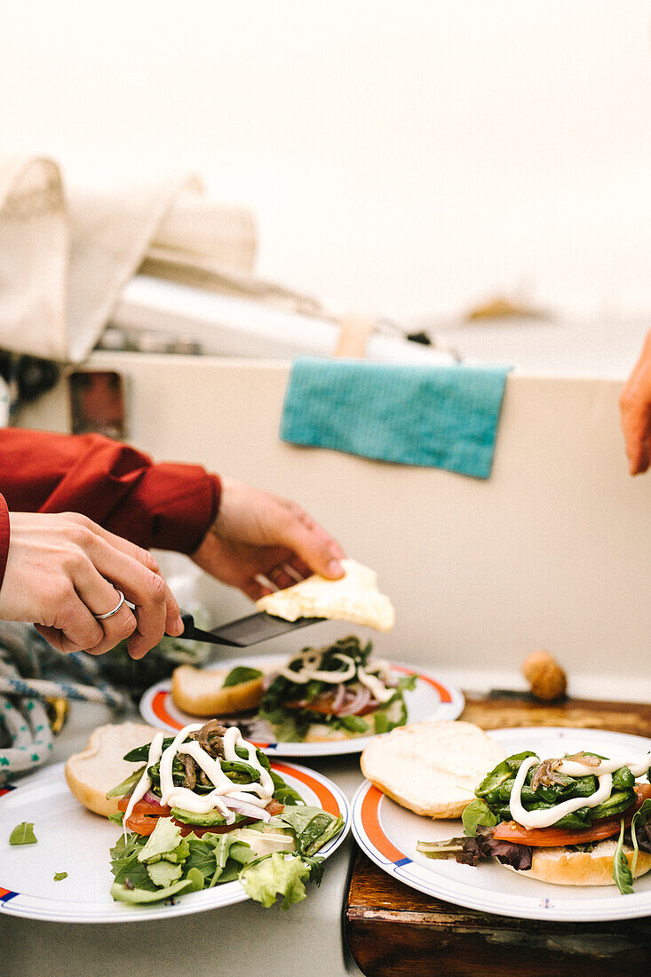 Frau macht Sandwiches auf einem Boot