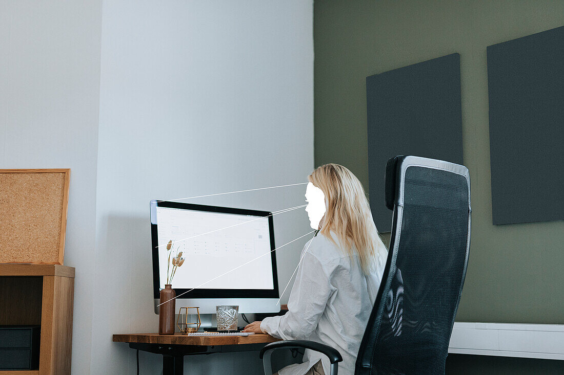 Faceless businesswoman working at computer