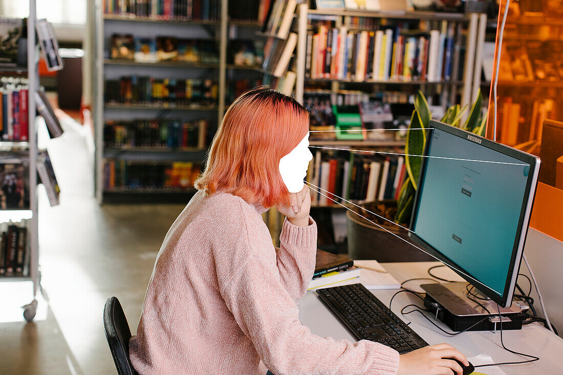 Female student using computer in library