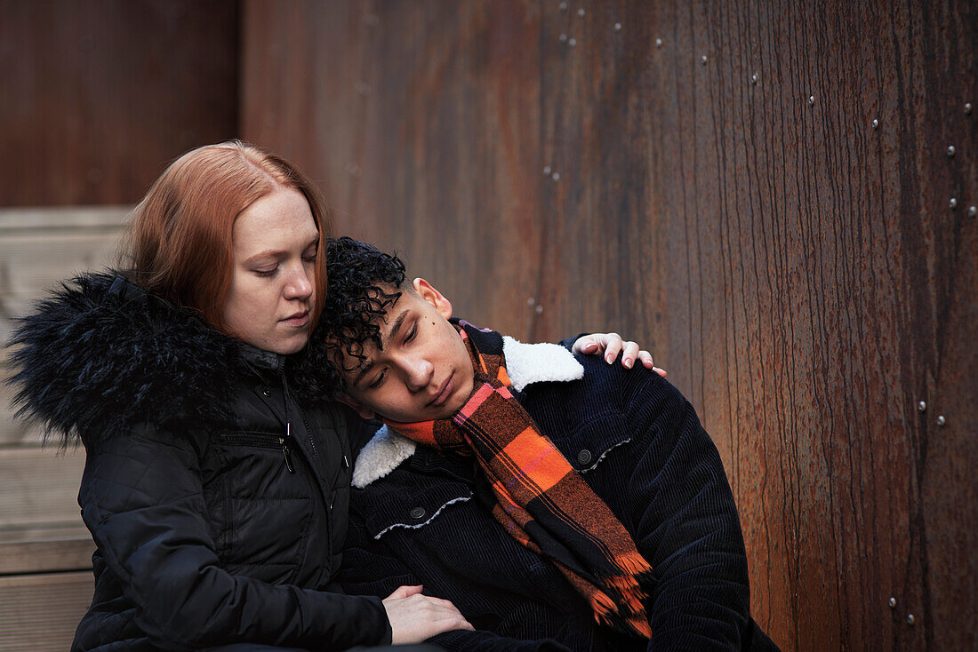 Young woman hugging and comforting boy