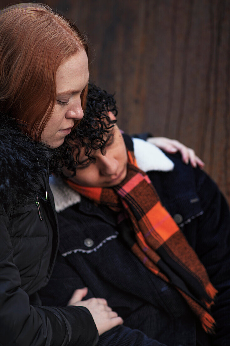 Young woman hugging and comforting boy