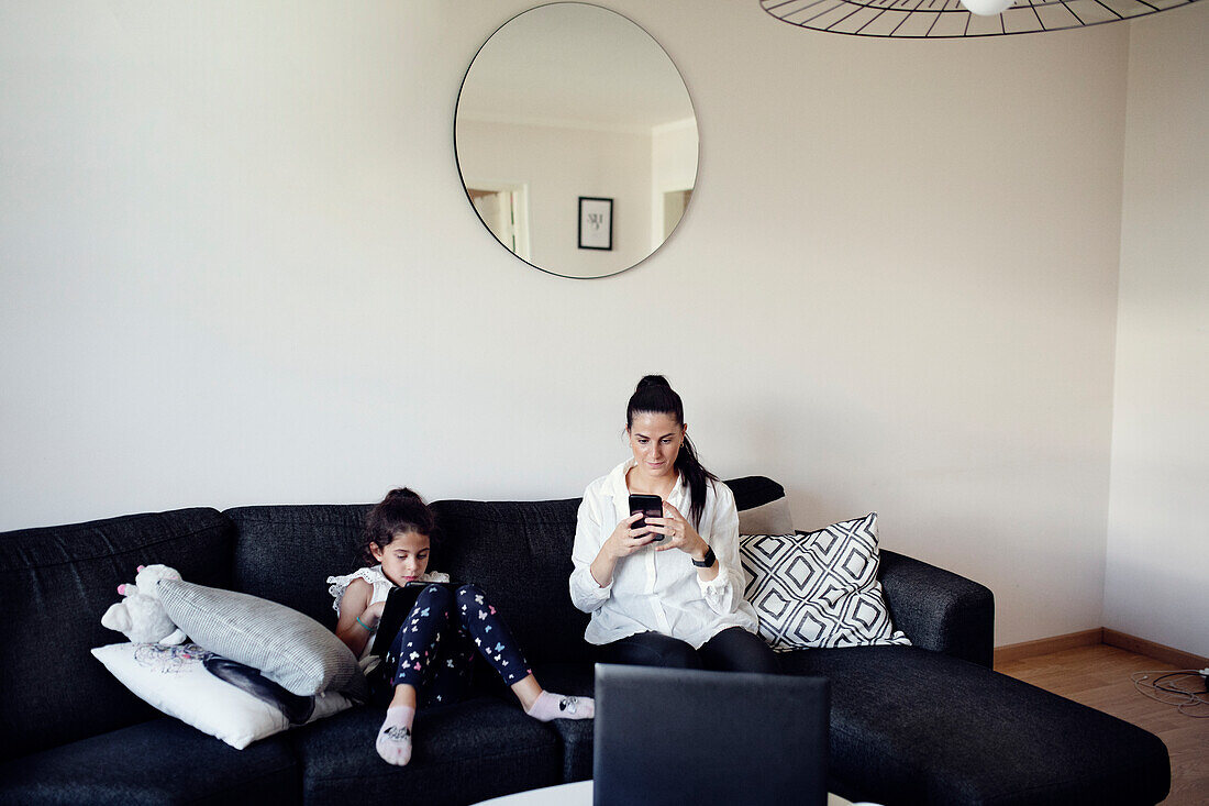 Mother and daughter on sofa