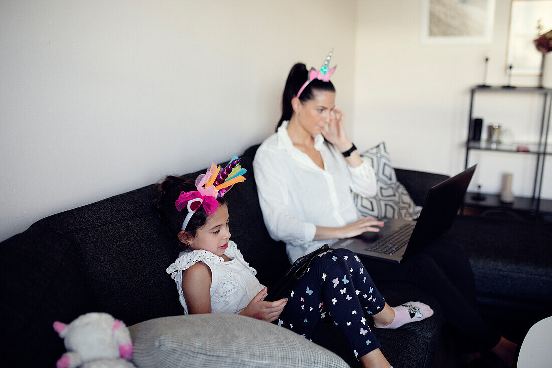 Mother and daughter on sofa