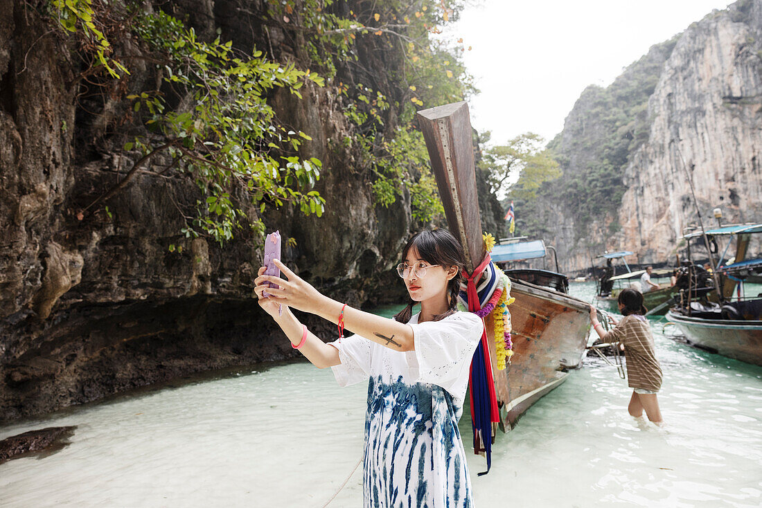 Teenage girl taking selfie in canyon