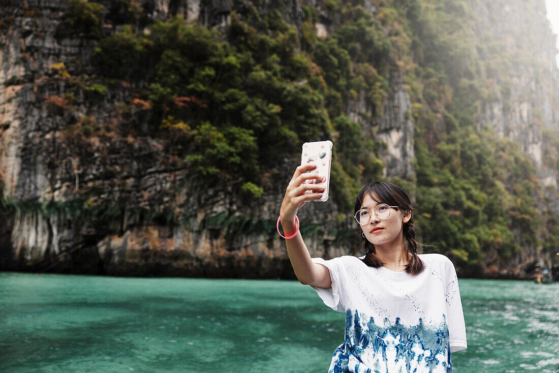 Teenage girl taking selfie in canyon