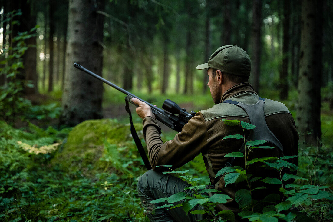 Hunter waiting in forest