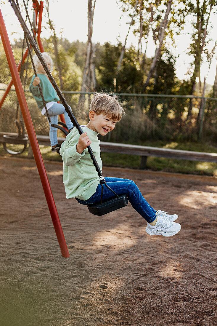 Smiling boy swinging