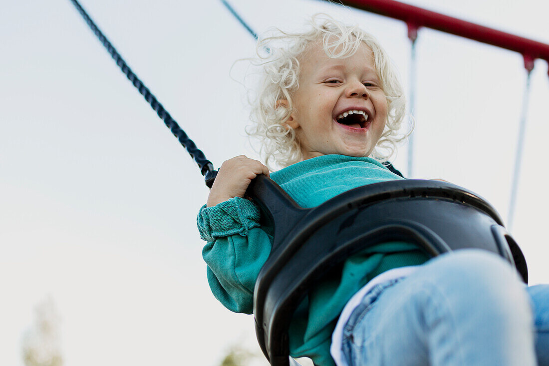 Happy child swinging