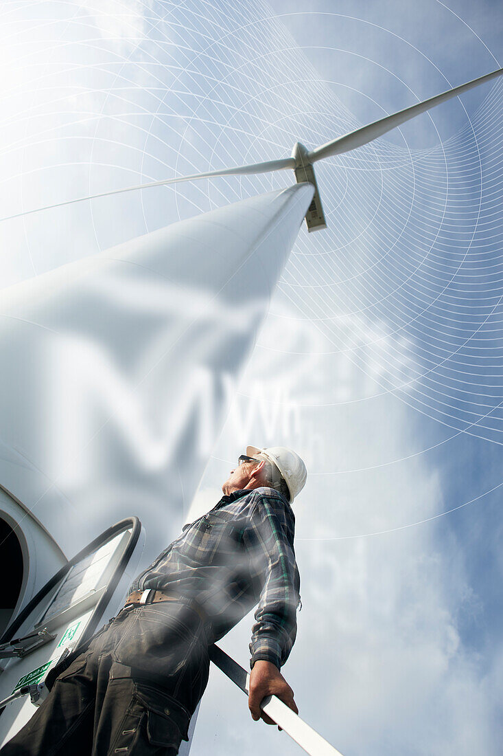 Engineer looking at wind turbine