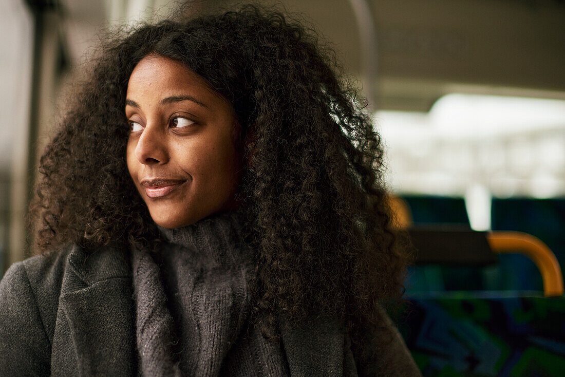 Woman in bus looking through window