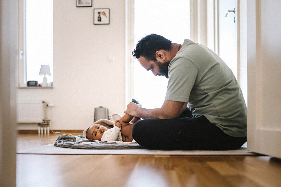 Vater mit Baby auf dem Boden