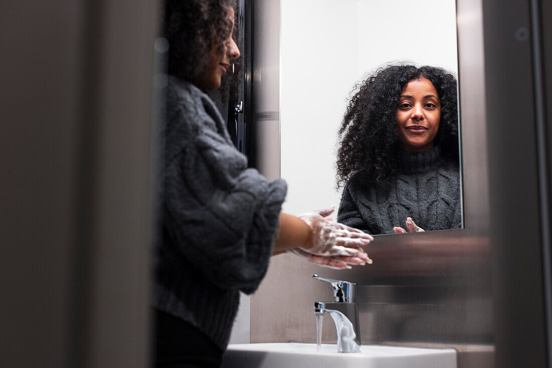 View of woman washing hands