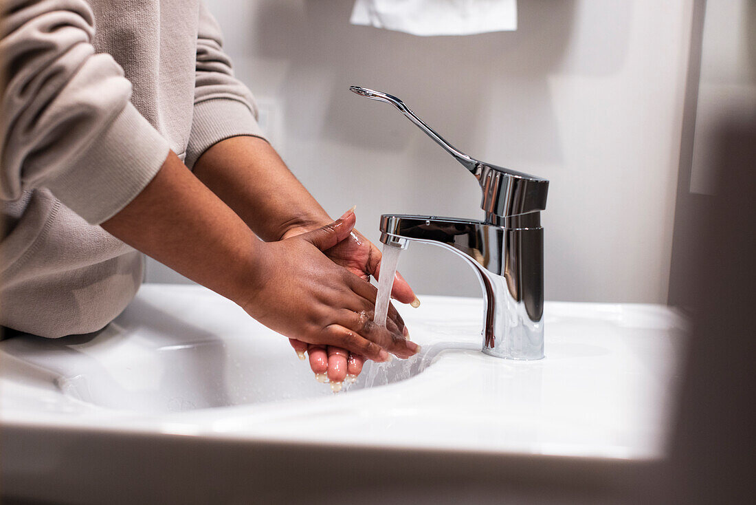 Mid section of woman washing hands