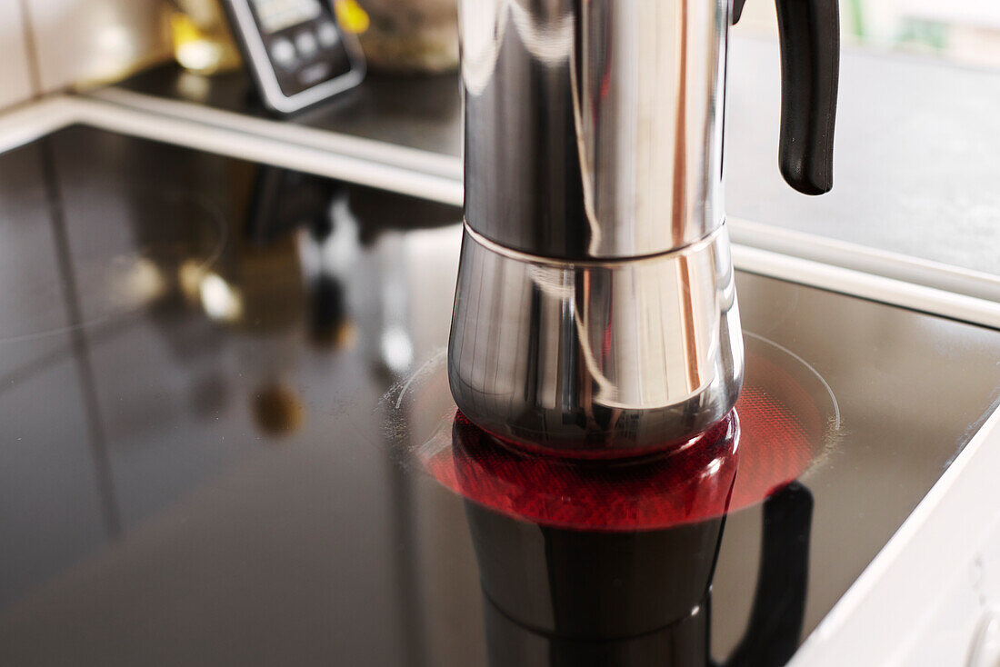 Close up of coffee maker on electric stove burner