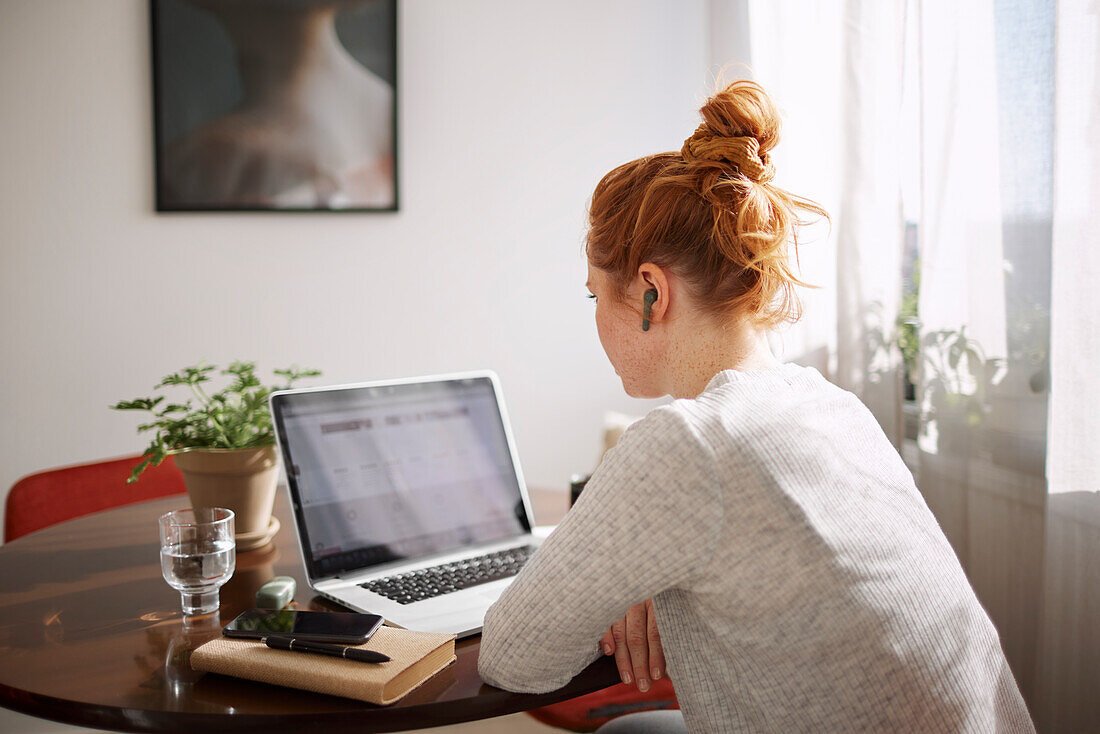 Woman using laptop at home