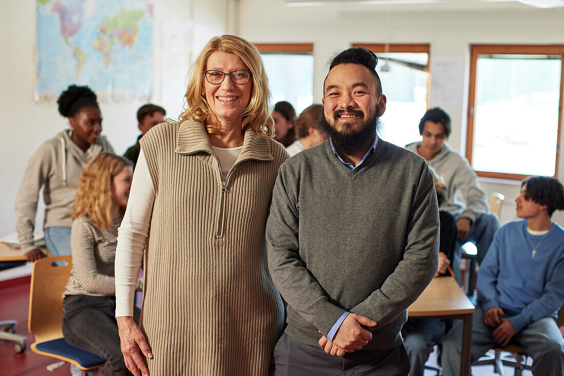 Portrait of teachers with students in background