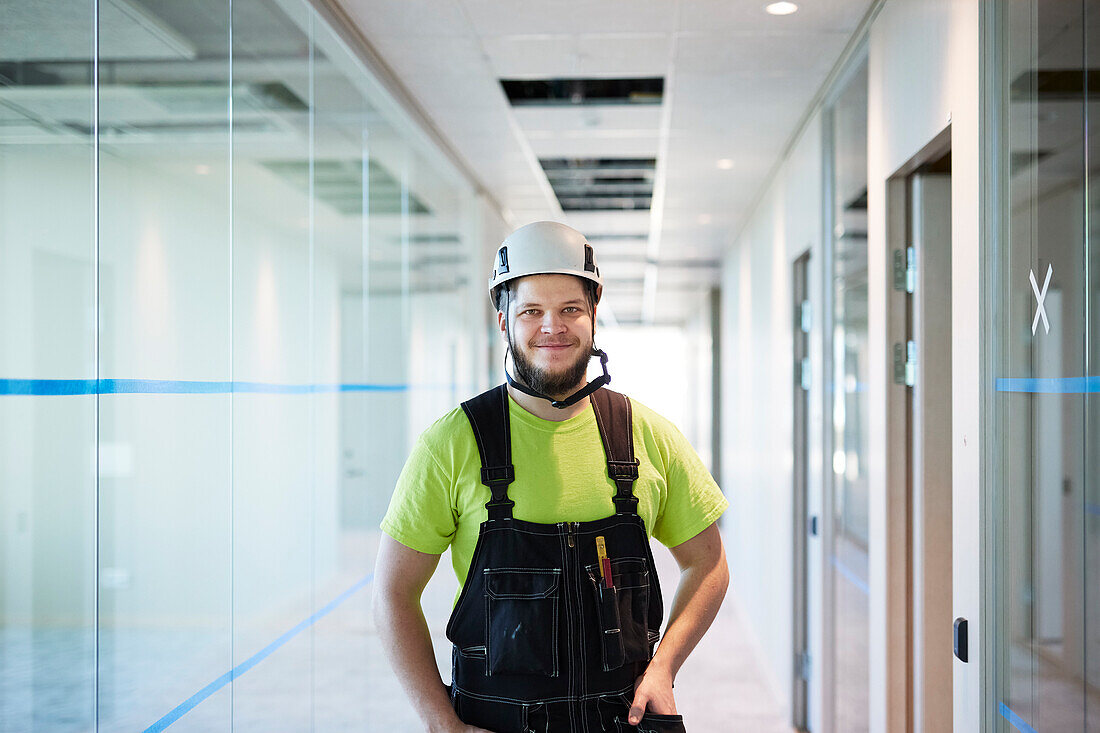Smiling worker standing at corridor