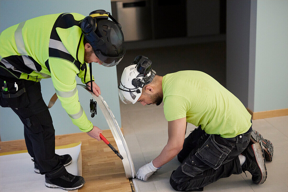 Workers installing floor