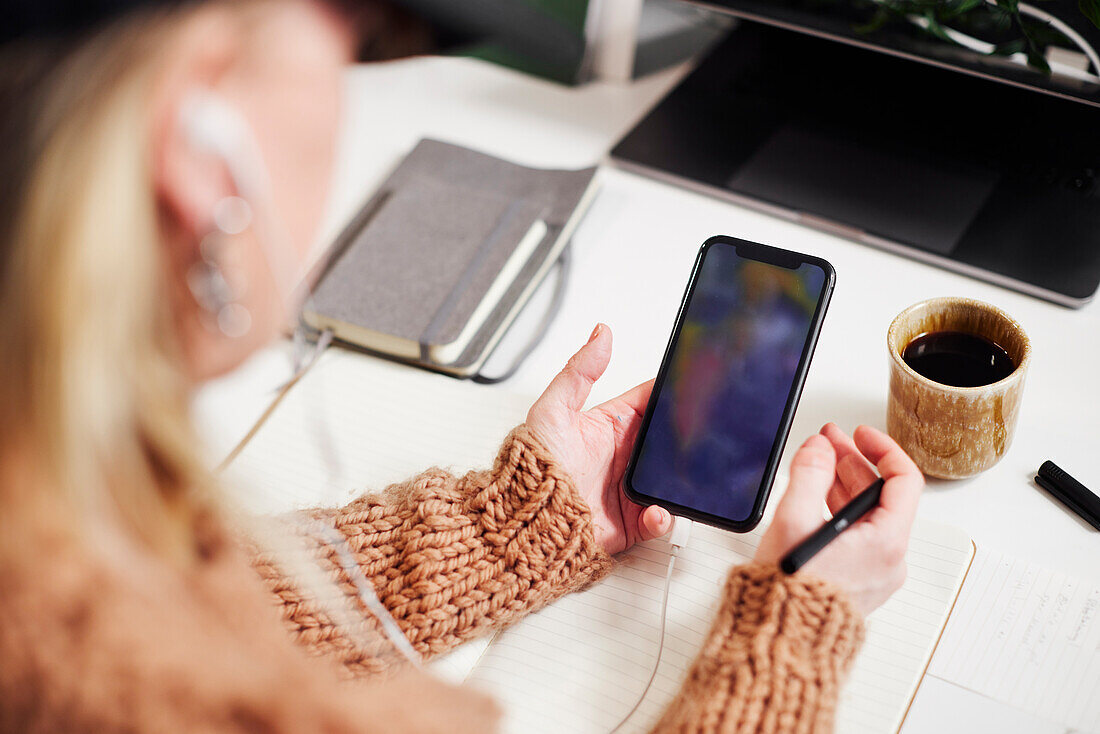 Woman's hands holding cell phone