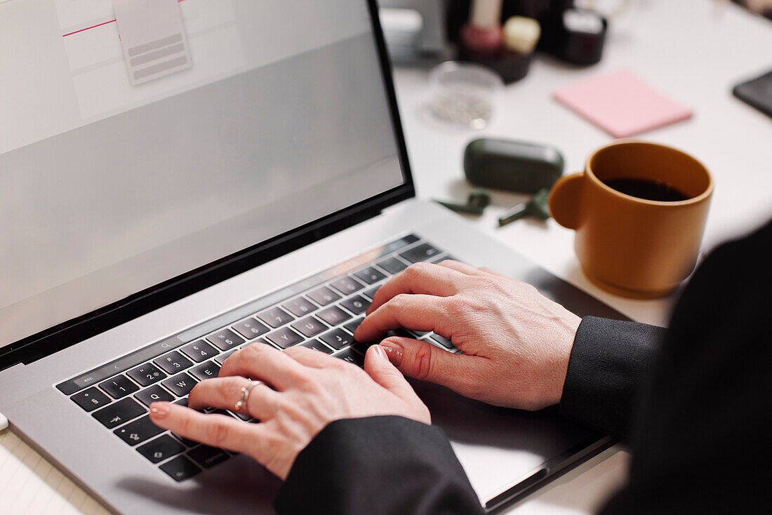 Woman's hands using laptop