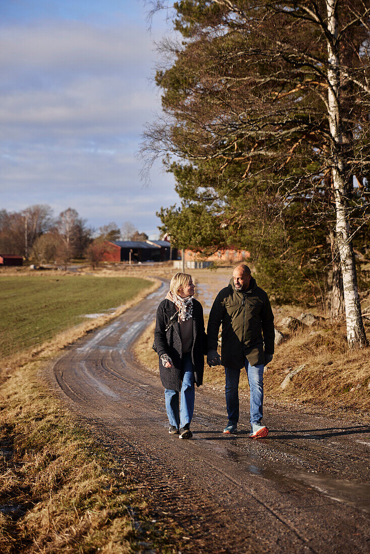 Couple walking on dirt road