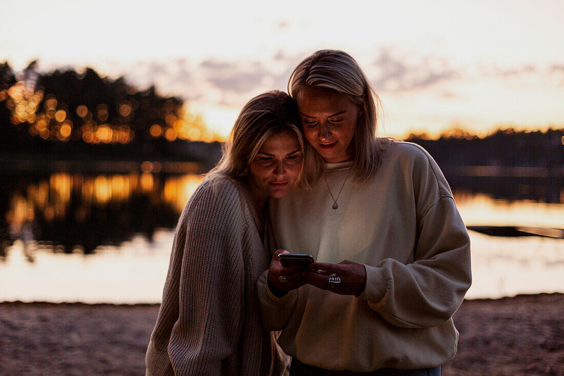 Female couple using cell phone