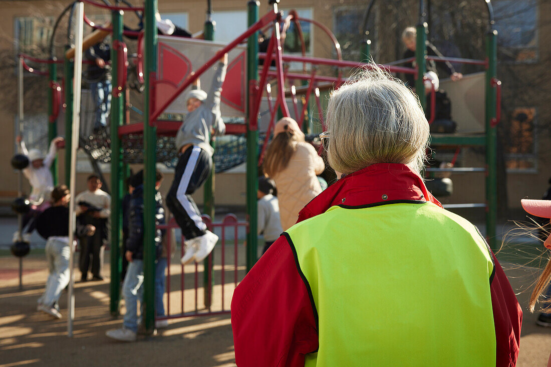 Guardian watching children on playground